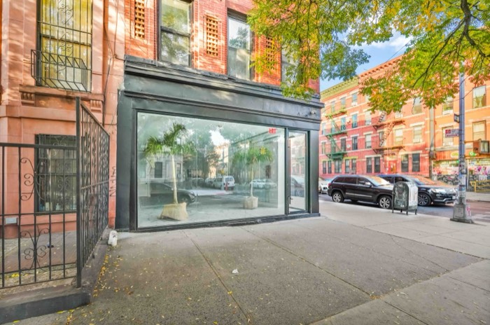 The venue's glass corner frontage seen from the sidewalk on Greene Avenue