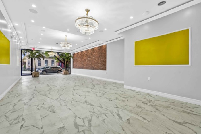 The hall looking toward the street through floor-to-ceiling glass