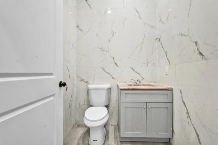 Restroom vanity and marble-clad walls